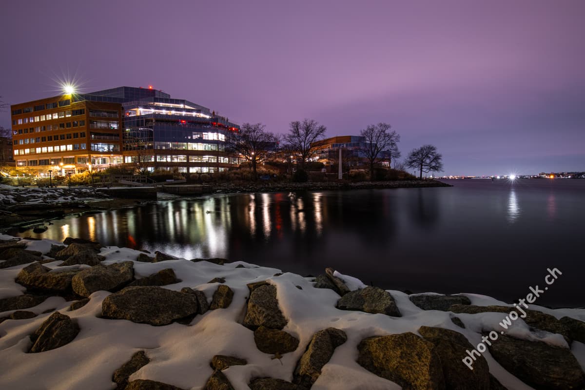 Office buildings by river at night Washington DC