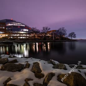 Office buildings by river at night Washington DC