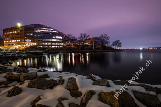 Office buildings by river at night Washington DC