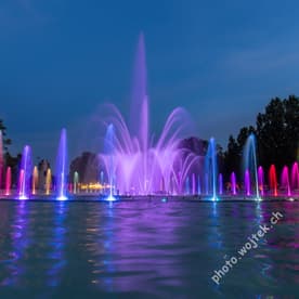 Colorful illuminated fountain at night Warsaw Poland