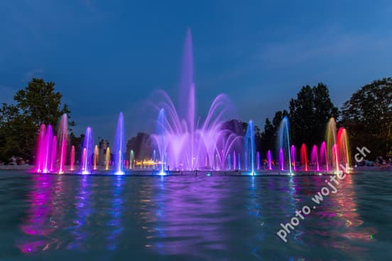 Colorful illuminated fountain at night Warsaw Poland