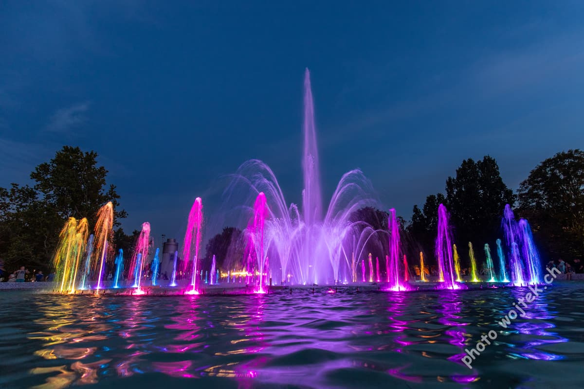 Colorful illuminated fountain at night Warsaw Poland