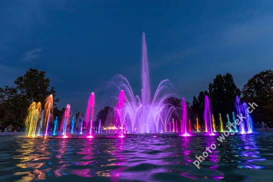 Colorful illuminated fountain at night Warsaw Poland