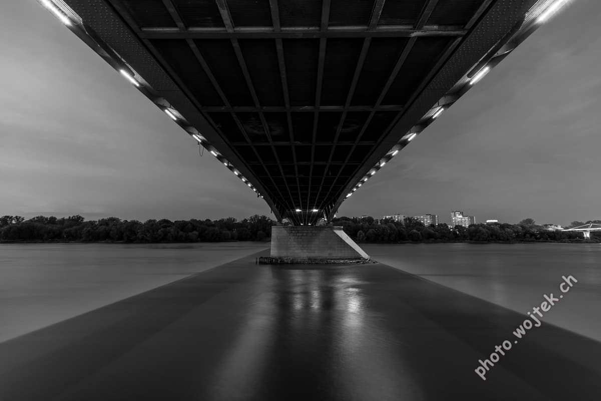Bridge underside over river at night Warsaw Poland