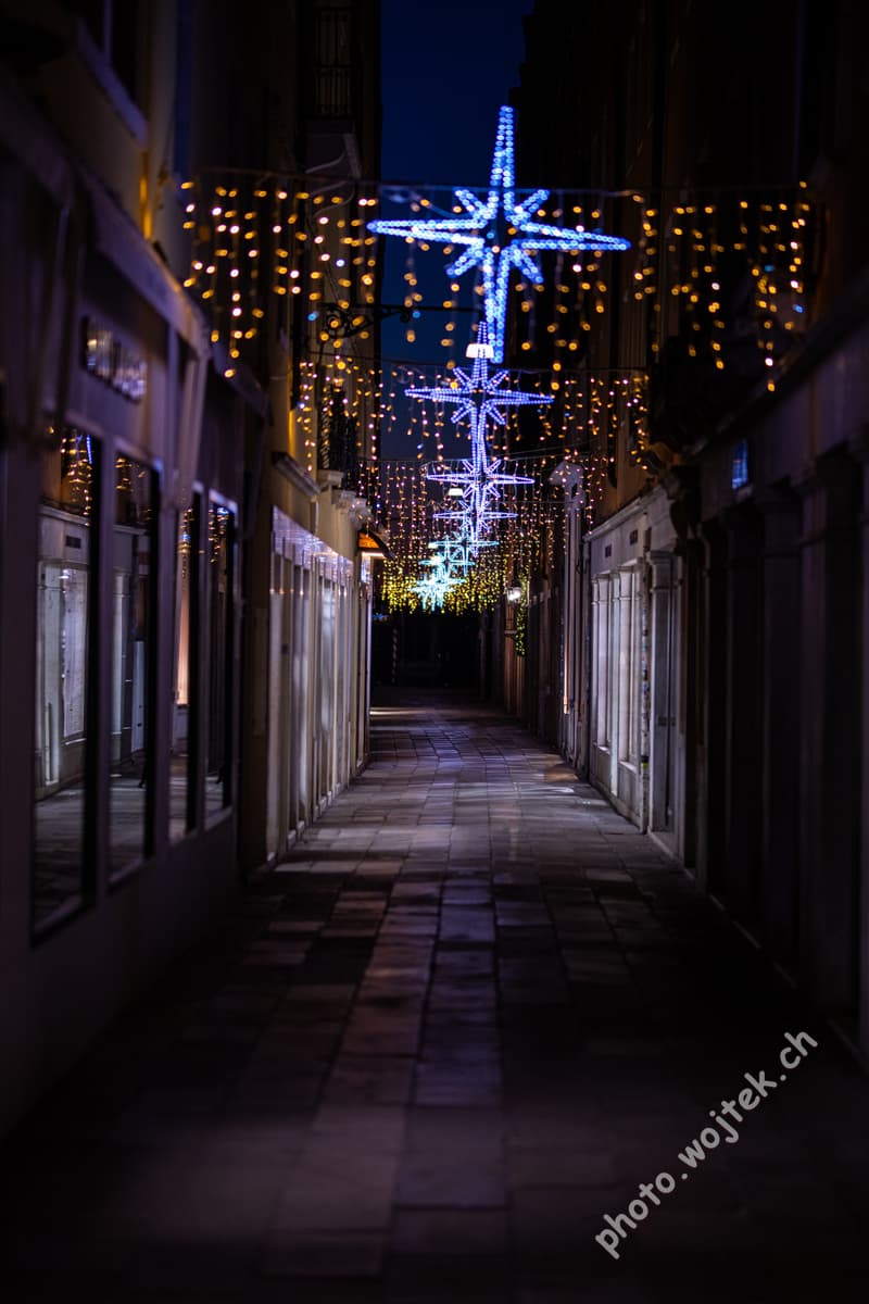 Christmas star lights on narrow street, Venice Italy