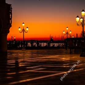 Sunset over gondolas and lampposts, Venice Italy