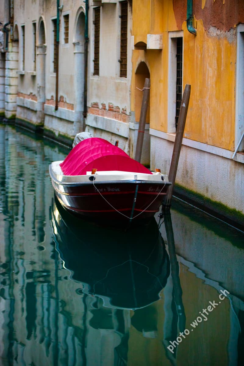 Covered boat in canal Venice Italy