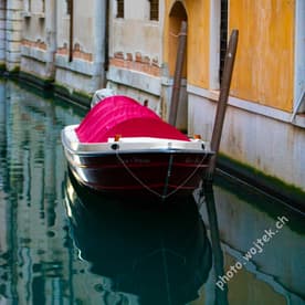 Covered boat in canal Venice Italy