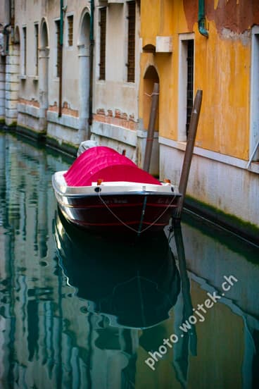 Covered boat in canal Venice Italy