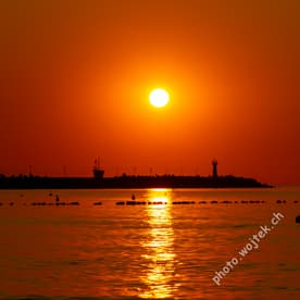 Sunset over harbor pier Kolobrzeg Poland