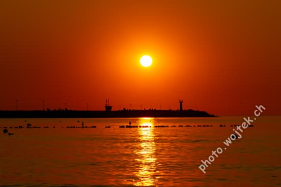 Sunset over harbor pier Kolobrzeg Poland