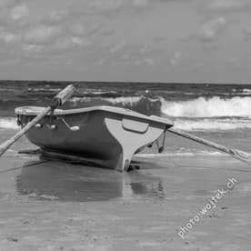 Rowboat on beach shore, Kolobrzeg Poland