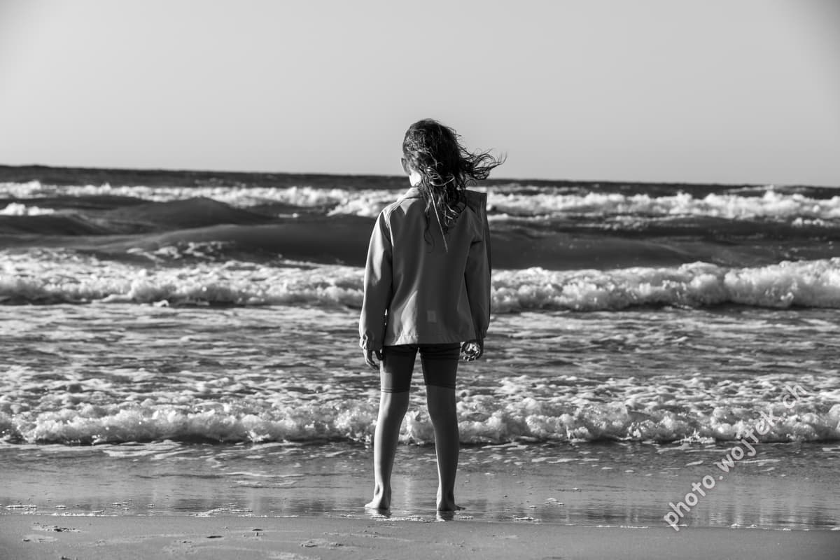 Child standing on beach Kolobrzeg Poland