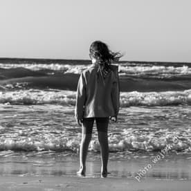 Child standing on beach Kolobrzeg Poland