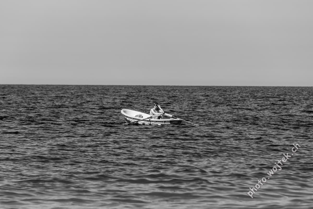 Man rowing boat on sea Kolobrzeg Poland