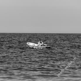 Man rowing boat on sea Kolobrzeg Poland