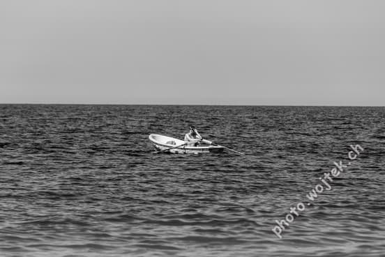 Man rowing boat on sea Kolobrzeg Poland