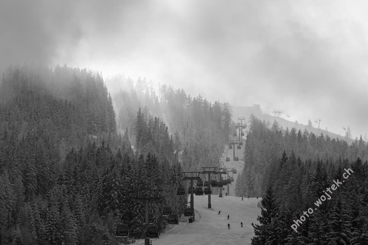 Skiers and Gondolas in Snowy Forest Schladming Austria