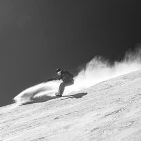 Snowboarder carving snow Schladming Austria