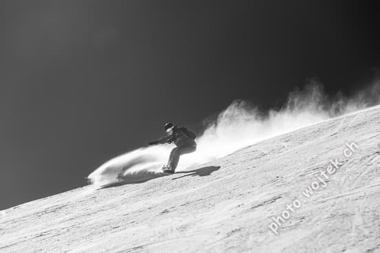 Snowboarder carving snow Schladming Austria