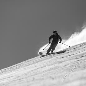 Skier carving snow slope Schladming Austria
