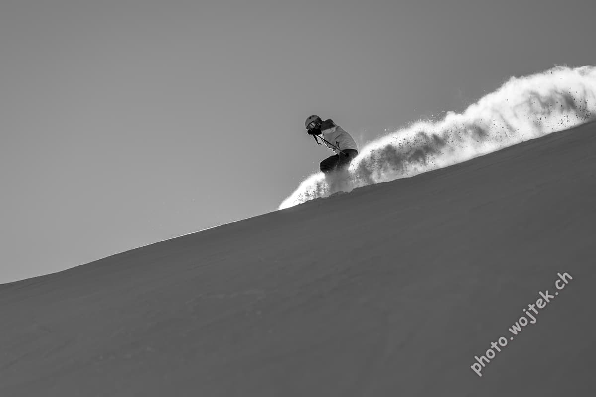 Snowboarder carving fresh powder, Schladming Austria