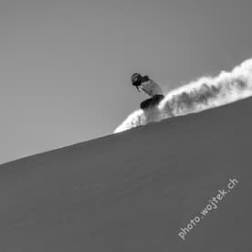 Snowboarder carving fresh powder, Schladming Austria