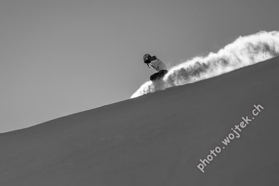 Snowboarder carving fresh powder, Schladming Austria