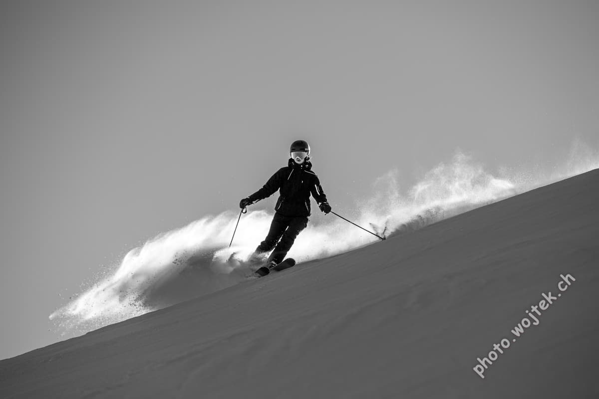 Skier carving fresh powder slope Schladming Austria