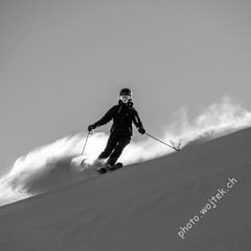 Skier carving fresh powder slope Schladming Austria