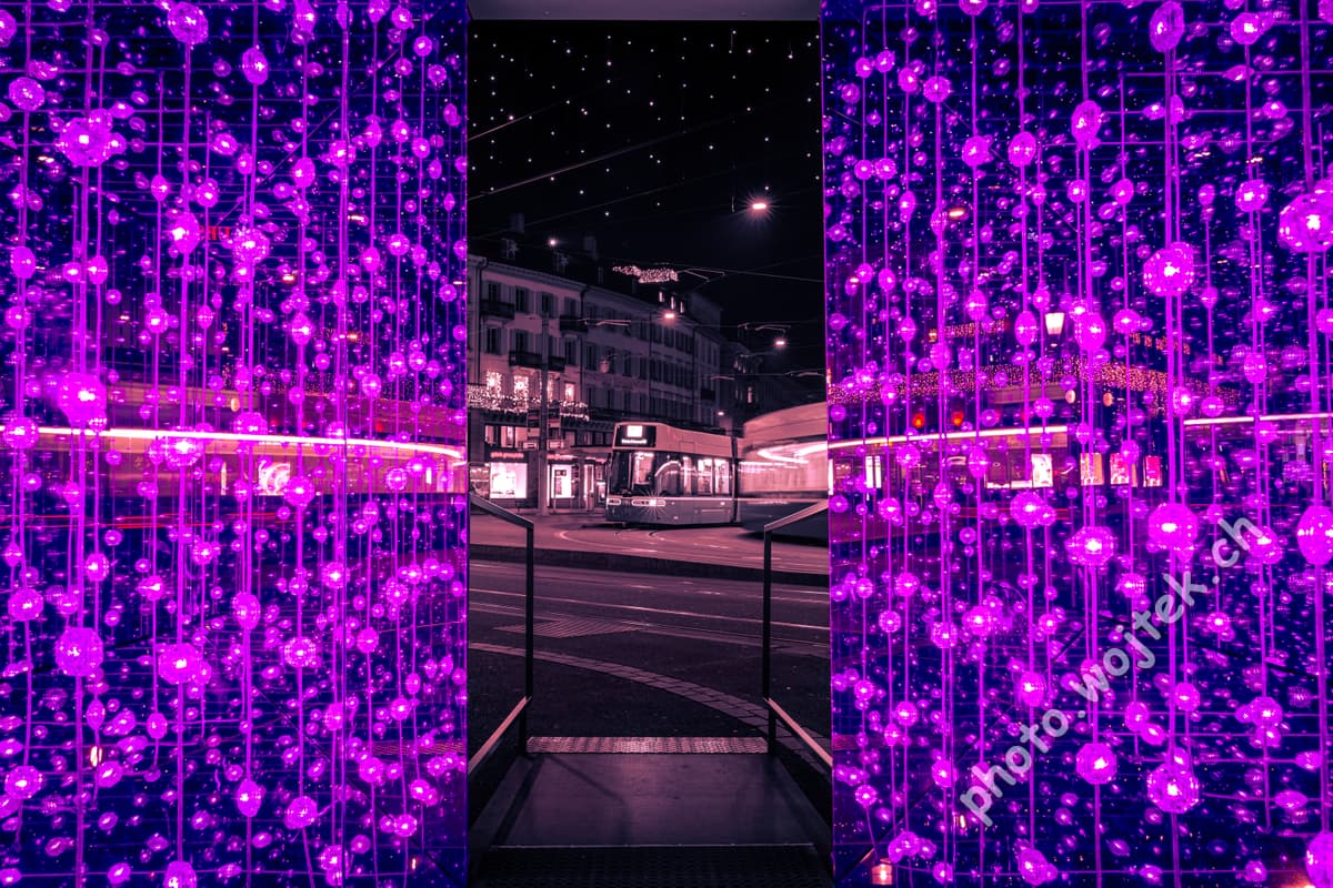 Purple light installation and tram at night, Zürich